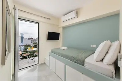 a bedroom with a bed and a balcony at Modern Colorful House 4 Rhodos in Rhodes Town