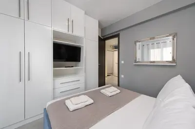 a bedroom with a bed with two towels on it at Modern Colorful House 4 Rhodos in Rhodes Town