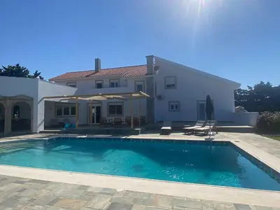a large swimming pool in front of a house at Villa Eos in Kalavárda