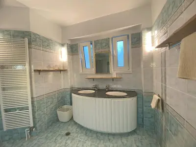 a bathroom with a large tub and a sink at Villa Eos in Kalavárda