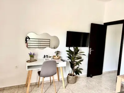 a dining room with a white table and a chair at Andreana's House Rhodes in Rhodes Town
