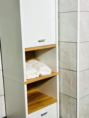 a white closet with wooden shelves and white towels at Andreana's House Rhodes in Rhodes Town