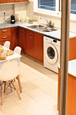 a kitchen with a sink and a washing machine at KMS Summer House Ialisos in Rhodes Town