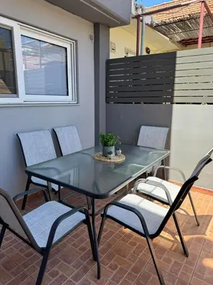 a blue table and chairs on a patio at KMS Summer House Ialisos in Rhodes Town