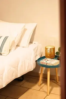 a bed and a table with a book on it at KMS Summer House Ialisos in Rhodes Town