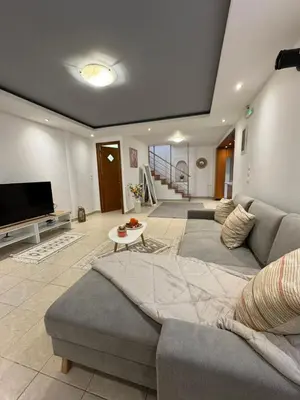 a living room with a couch and a tv at KMS Summer House Ialisos in Rhodes Town