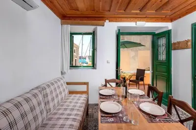 a living room with a table and a couch at Matina's House in Halki
