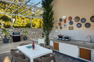 a kitchen with a table and some plates on the wall at Adamas Villa Rhodes in Rhodes Town