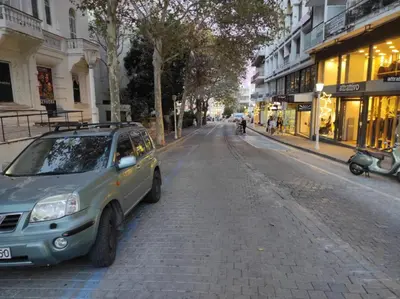 a small car parked on the side of a street at SEAL of Deer - Castle View - 5 minute walk to the Beach in Rhodes Town