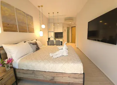 a bedroom with a bed with a white dog on it at SEAL of Deer - Castle View - 5 minute walk to the Beach in Rhodes Town