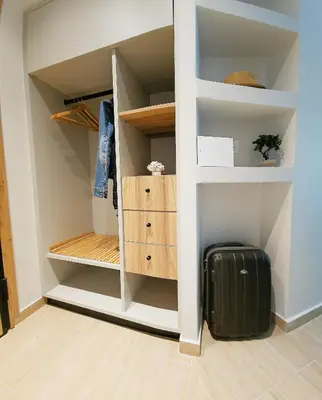 a room with a closet with a suitcase at SEAL of Deer - Castle View - 5 minute walk to the Beach in Rhodes Town