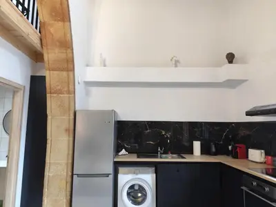 a kitchen with a refrigerator and a washing machine at Lindos Central in Líndos