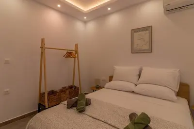 a bedroom with a bed with white sheets at Onda Blu in Rhodes Town