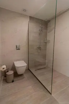 a bathroom with a shower with a toilet and a glass shower stall at Onda Blu in Rhodes Town