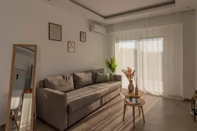a living room with a couch and a table at Onda Blu in Rhodes Town