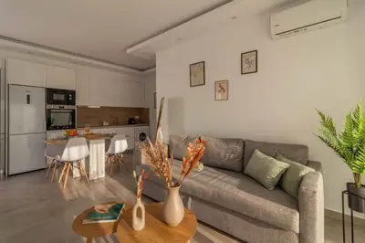 a living room with a couch and a table at Onda Blu in Rhodes Town