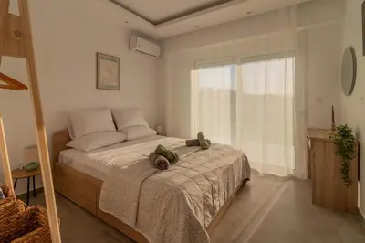 a bedroom with a bed with two teddy bears on it at Onda Blu in Rhodes Town