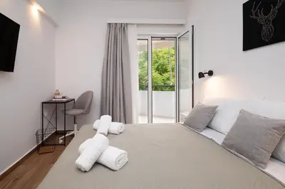 a bedroom with a large bed with white pillows at Gravity Downtown Balcony Studio in Rhodes Town