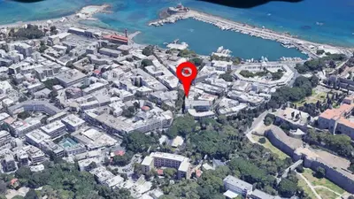 an aerial view of a city with a red marker at Gravity Downtown Balcony Studio in Rhodes Town