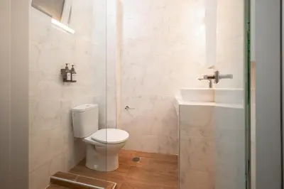 a bathroom with a toilet and a sink at Gravity Downtown Balcony Studio in Rhodes Town