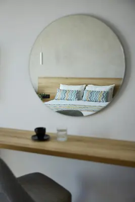 a mirror over a bed in a bedroom at Sunrise Hotel in Pefki Rhodes