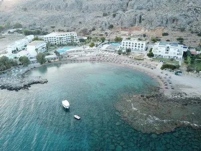 an aerial view of a beach with a boat in the water at Sunrise Hotel in Pefki Rhodes