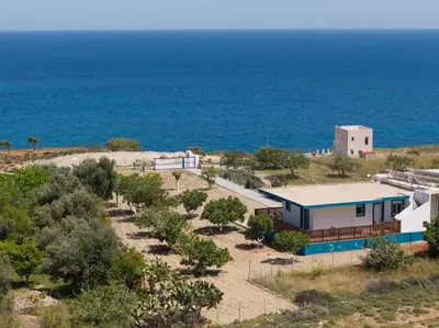 an aerial view of a house with the ocean in the background at Laftiras Sea View Home in Archangelos
