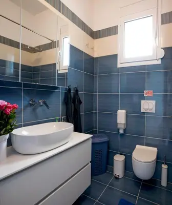 a bathroom with a sink and a toilet at Laftiras Sea View Home in Archangelos