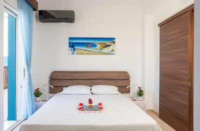 a bedroom with a bed with a bowl of fruit on it at Laftiras Sea View Home in Archangelos