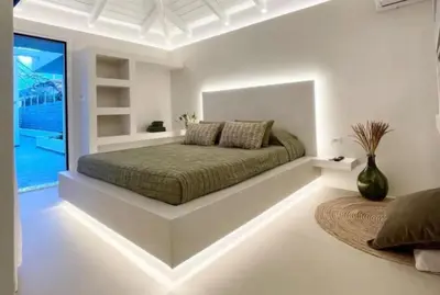 a white bedroom with a bed with a large window at White House Luxury Apartment of Rhodes in Kremasti