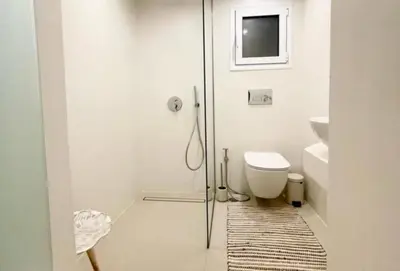 a bathroom with a toilet and a glass shower at White House Luxury Apartment of Rhodes in Kremasti