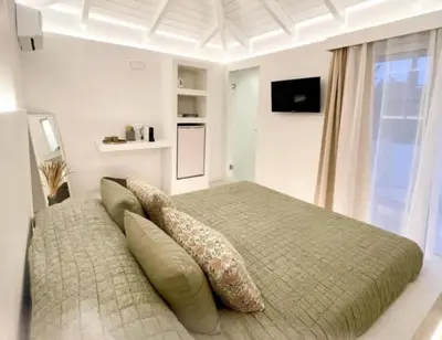 a bedroom with a bed with pillows on it at White House Luxury Apartment of Rhodes in Kremasti