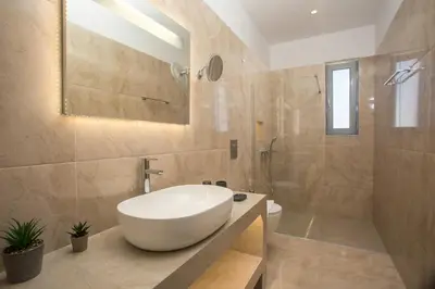 a bathroom with a large white sink and a shower at Twin Villas Gennadi in Gennadi