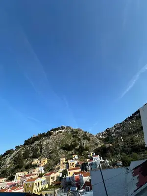 a group of houses on top of a mountain at Seaside escape in Symi