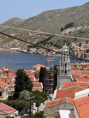 a view of a city with a mountain and a town at Seaside escape in Symi