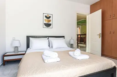 a bedroom with a bed with two towels on it at Terra Ventura Villa At The Hill in Triánta