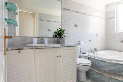 a bathroom with a sink and a toilet and a mirror at Terra Ventura Villa At The Hill in Triánta