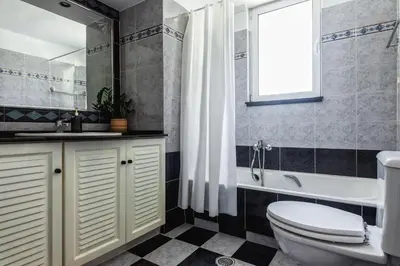 a bathroom with a toilet and a tub and a sink at Terra Ventura Villa At The Hill in Triánta