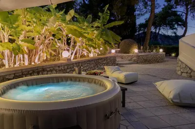 a jacuzzi tub in a garden at night at Terra Ventura Villa At The Hill in Triánta