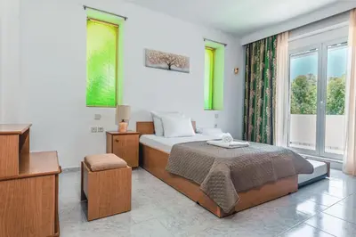 a bedroom with a bed and a large window at Terra Ventura Villa At The Hill in Triánta