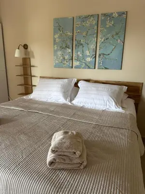 a white bed with a towel on top of it at Katalyma Thalassa in Ixia