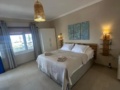 a bedroom with a large bed with towels on it at Katalyma Thalassa in Ixia