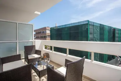 a balcony with chairs and a table and a building at DownTown Horizon View in Rhodes Town