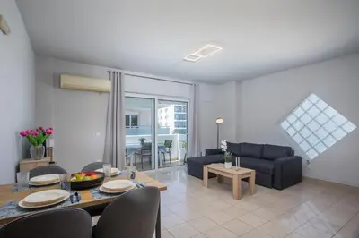 a living room with a couch and a table at DownTown Horizon View in Rhodes Town