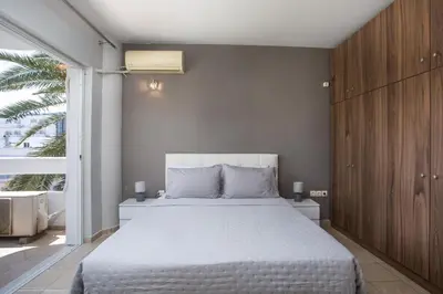 a bedroom with a large bed and a large window at DownTown Horizon View in Rhodes Town