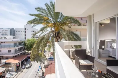 a balcony with a palm tree and a view of a city at DownTown Horizon View in Rhodes Town
