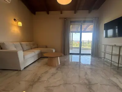 a living room with a couch and a table at Katalyma Vouno in Ialyssos
