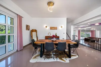 a dining room with a wooden table and chairs at Diamanti Villa Prime Location in Rhodes Town
