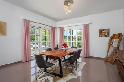 a dining room with a wooden table and chairs at Diamanti Villa Prime Location in Rhodes Town