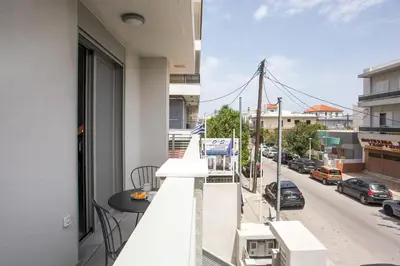 a balcony with a table and a view of a street at Casadi City Apartment in Rhodes Town